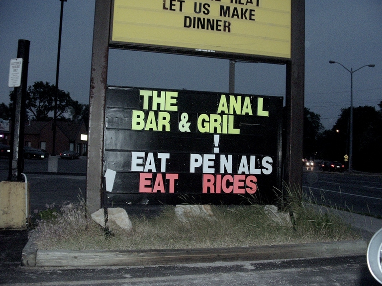 A sign reading -The Anal Bar and Grill - Eat Penals Eat Rices