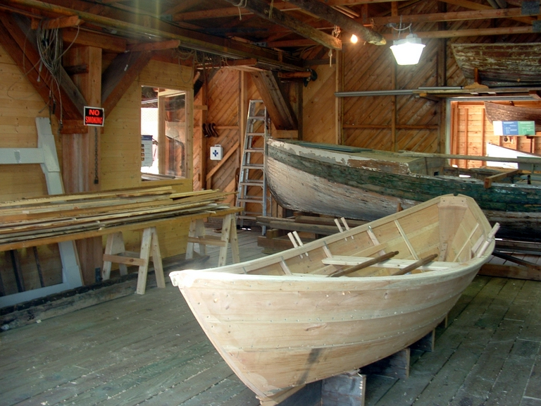 A boat workshop with an out-of-place looking sign